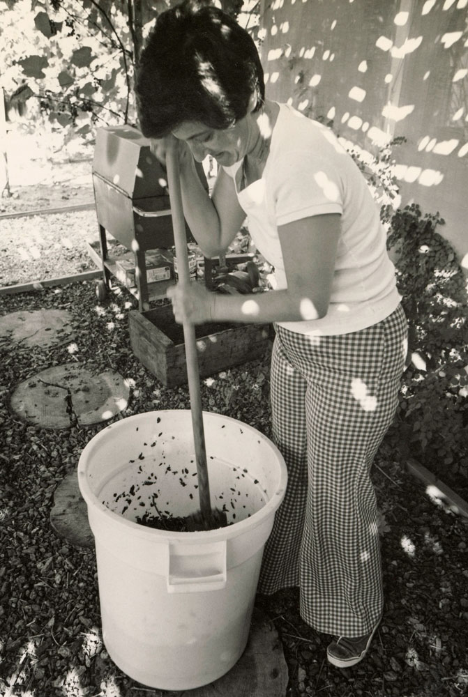 Margaret punching down grapes at the Zuech home vineyard in Westlake